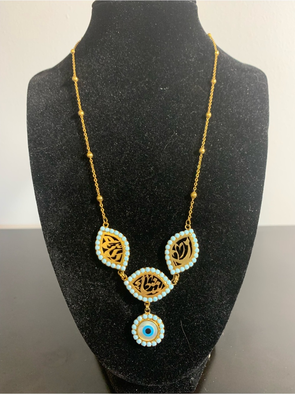 Gold-Tone Necklace with Light Blue Bead Accents and Dangle Matia